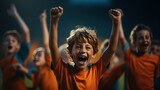Fototapeta Sport - A team of cheerful children's soccer players joyfully celebrate their victory on the sports field.