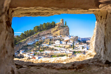 Wall Mural - Scenic white village of Montefrio near Granada view through stone window