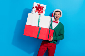 Canvas Print - Photo of excited positive man wear x-mas green cardigan rising presents pile isolated blue color background