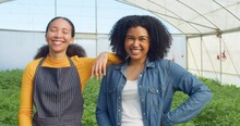 Portrait Of Two Female Farmers Standing In Greenhouse Field Smiling And Laughing
