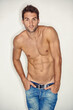 Sexy, topless and portrait of man or model for fitness, sports or muscle on a studio background. Health, cool and a guy or person with abs or stomach from exercise, training or jeans on a backdrop