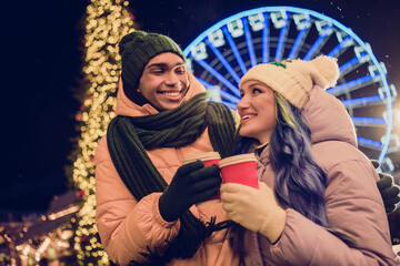 Sticker - Photo of charming dreamy american guy lady wear windbreakers hugging enjoying xmas cacao together outside urban ferris wheel market park