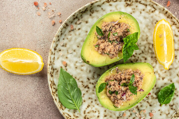 Wall Mural - Salad of avocado and tuna on a light background top view. place for text