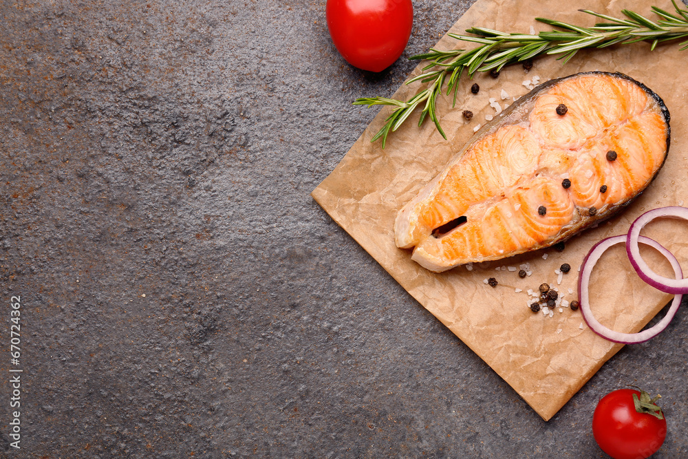 Tasty grilled salmon steak on brown background