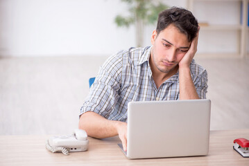 Young male employee working in the office