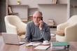 © Elnur - Old male employee working from home during pandemic