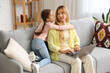 © Pixel-Shot - Little girl hugging her working mother at home