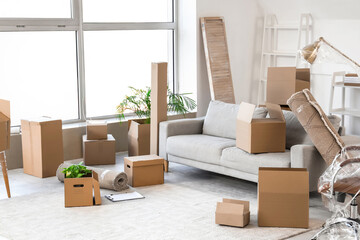 Poster - Sofa with cardboard boxes in living room on moving day