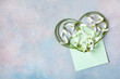 Envelope with snowdrop flowers in the shape of a heart, a beautiful card for the holidays in March, space for congratulation text