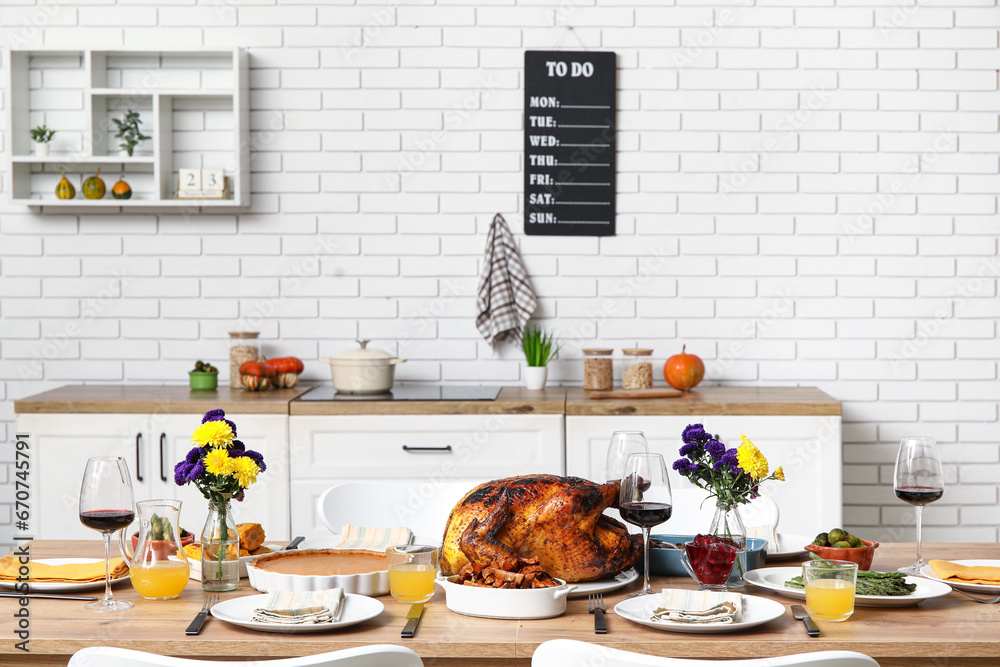 Festive dining table with tasty food for Thanksgiving Day in kitchen
