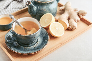 Wall Mural - Ginger tea with lemon in a blue cup