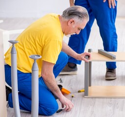 Two contractors carpenters working indoors