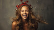 Laughing girl with ornaments on head made of Christmas balls