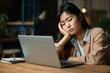 © MariaJos - Exhausted Asian woman sits overworked needs rest fatigue taking nap near laptop. Tired Chinese girl