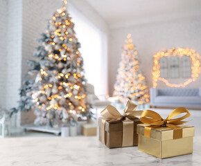 Poster - Gift boxes on white marble table in room decorated for Christmas, space for text