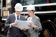 © NT_studio - Young caucasian engineer man and woman in suit checking train looking blueprint in station, team engineer inspect system transport, technician examining infrastructure, transportation and industry.