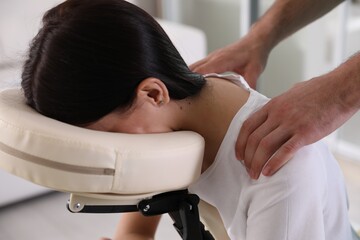 Sticker - Woman receiving massage in modern chair indoors, closeup