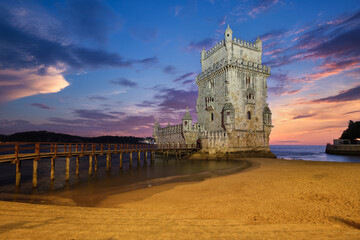 Wall Mural - Belem Tower or Tower of St Vincent - famous tourist landmark of Lisboa and tourism attraction - on the bank of the Tagus River (Tejo) after sunset in dusk twilight with dramatic sky. Lisbon, Portugal