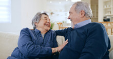 Home, conversation and senior couple on a couch, love and happiness with retirement in a living room. Romance, old man and elderly woman on a sofa, support and funny with humor, laughing and cheerful