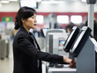 © kalafoto - Asian-american business women use self-checkout devices in supermarkets