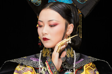 A Asian woman dressed in Qing Dynasty Empress attire