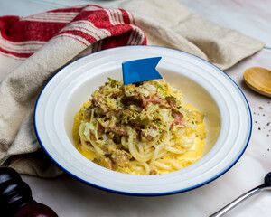 Wall Mural - Grilled Carbonara Chicken with Fish Udon served in plate isolated on napkin side view italian cuisine on table