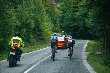 Wall Mural - Cycling road race. Two cyclist riding together in green summer nature. Sport photo, edit space