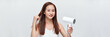 Crop attractive young female holding blow dryer on white banner background
