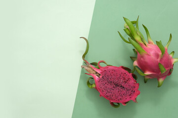 Sticker - Dragon fruit with half isolated on pastel background. Space on the left for text design and inserting product images. Flat lay. Food and cosmetic with dragon fruit extract.