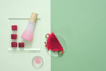 Sticker - Red dragon fruit, pink ceramic bottle with wooden lid, petri dish are randomly decorated on a minimalist background. Dragon fruit is a fruit from the tropics, containing many nutrients and vitamins.