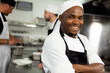 © Wavebreak Media - Portrait of happy african american male chef standing with arms crossed in restaurant kitchen