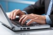 © Ilja - Close-Up of Hand Typing on Laptop Keyboard in Well-Lit Office for Online Marketing and Work