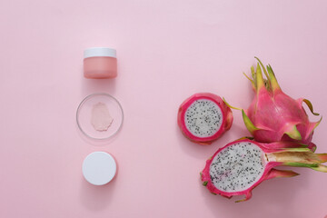 Sticker - Top view of unlabeled cosmetic jar with fresh dragon fruit and some props on pink background. Health and beauty themes. Image suitable for magazines.