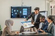 © BESTIMAGE - Speaker Motivational multiracial teamwork by present document to colleagues decide. coworker coach explain Analysis Statistics Report drawing presentation to multiethnic business improvement teamwork.
