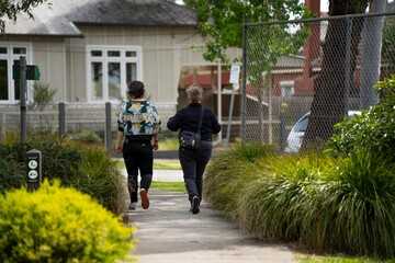 lesbian couple walking together in a park