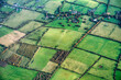 An aerial view of the rural landscape around Dublin Airport , Ireland, showing a patchwork of green fields divided by hedgerows and trees.