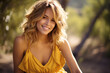 © Ema - A blonde woman model wearing a yellow sundress in the garden