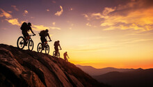 Low Angle View Of Row Of Cross Country Bikers Traveling In Mountain Landscape At Sunset
