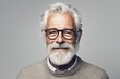 Serious older man in casual with beard head shot portrait. Grey haired retiree, pensioner posing, standing. Portrait of active senior man smiling. Old grey haired man with beard and glasses portrait.