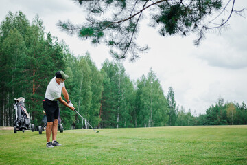 Canvas Print - Male golfer plays golf on golf course