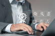 © Pakin - Quality management and Quality control certification, Businessman using computer laptop with quality assurance icon for compliance to regulations and standards.