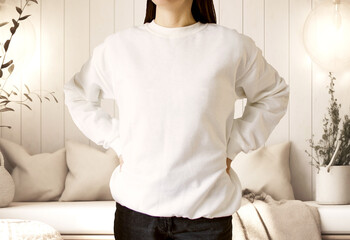 Wall Mural - White sweatshirt mockup in a photo studio. Female wear plain