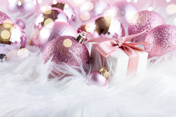 Canvas Print - Pink Christmas decorations on white fur background