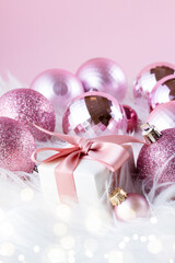 Canvas Print - Pink Christmas decorations with gift box on white fur background