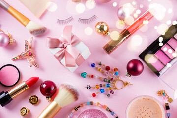 Wall Mural - Festive make up products on pink flat lay background