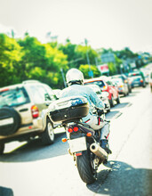 Motorcyclist In City Highway At Rush Hour