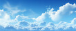 An ultra-wide clouds background capturing the heavenly view from up in the clouds. A serene expanse of blue sky adorned with billowing white clouds, evoking a tranquil and ethereal atmosphere