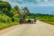 African road through village people going about business