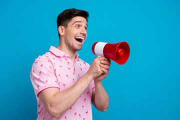 Poster - Profile photo of impressed positive person hold loudspeaker toa communicate empty space isolated on blue color background