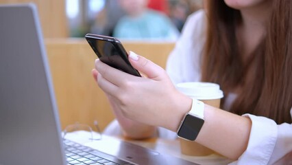 Business woman, hands and phone in research, communication or online networking on mall desk. Closeup of female working on laptop and mobile smartphone app at the workplace 4K